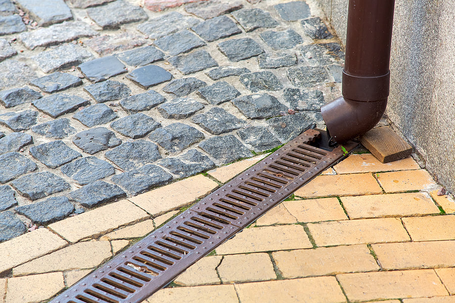 a gutter pointing into drain